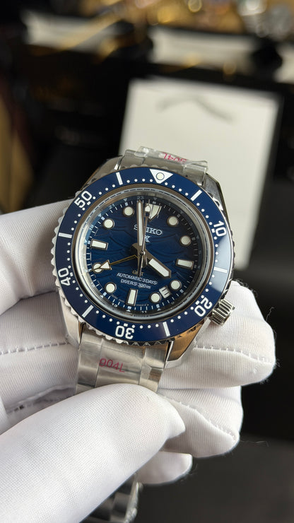 Silver with Aqua Dial.
