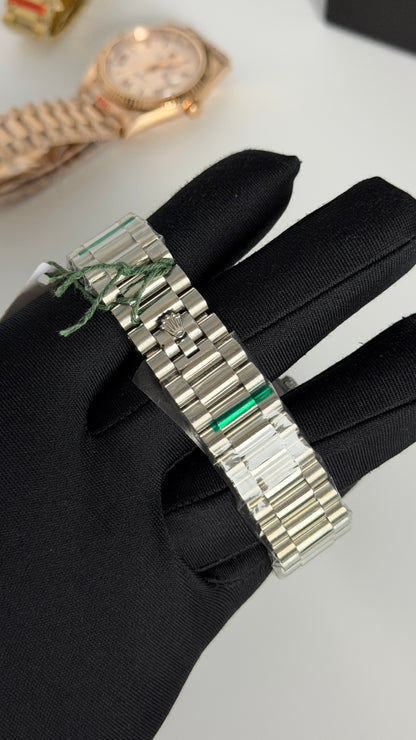 Silver with Green Dial.