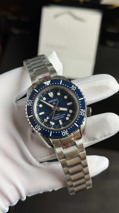 Silver with Aqua Dial.