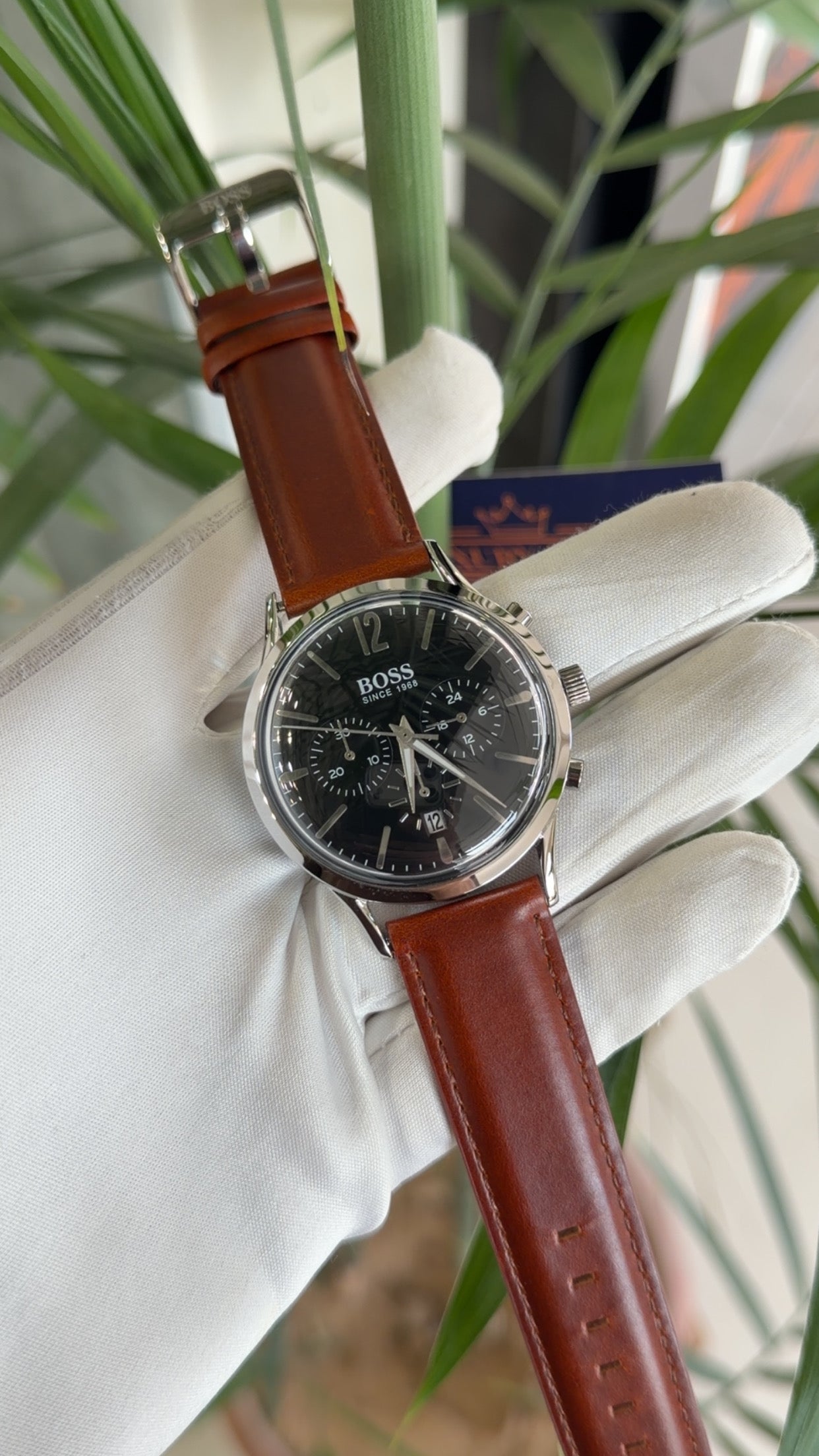 Silver with black dial and brown strap