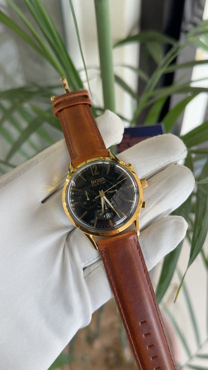 Yellow gold with black dial and brown strap