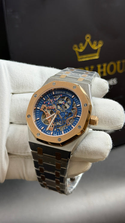 Rose Gold Two Tone with Blue Skeleton Dial.