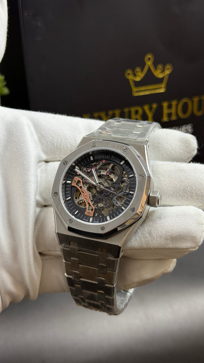 Silver with Black Skeleton Dial.