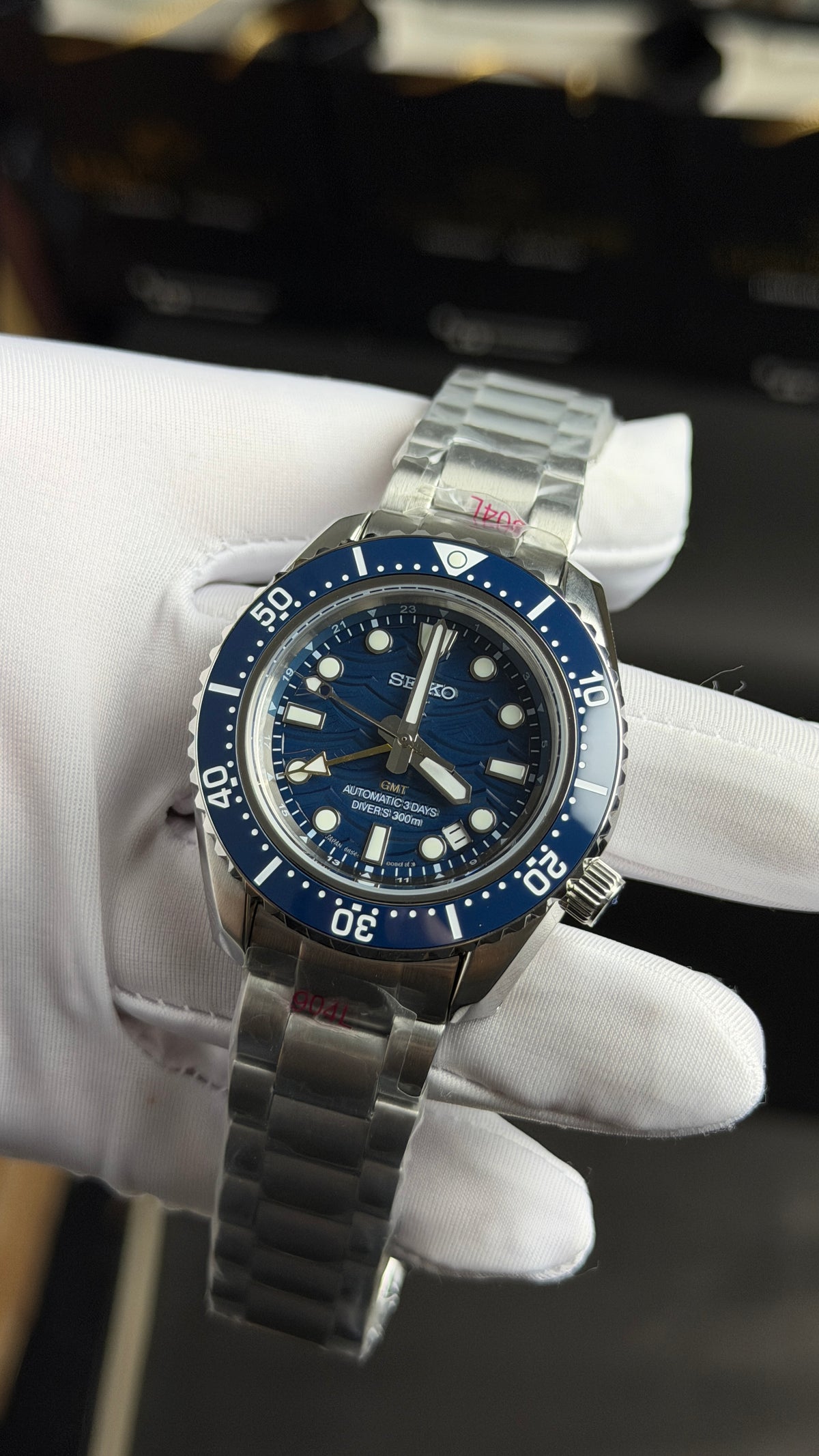 Silver with Aqua Dial.