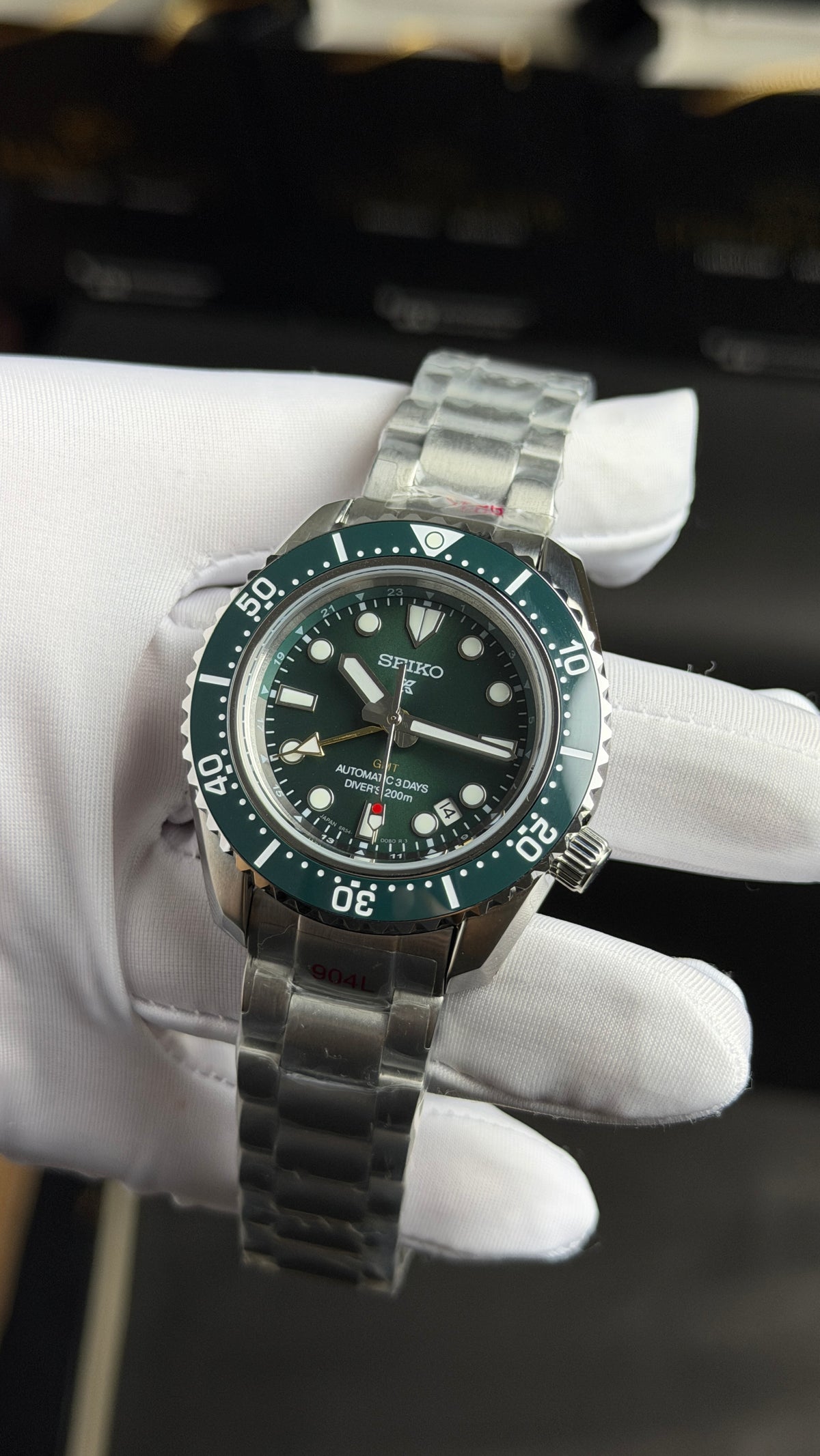 Silver with Green Dial.