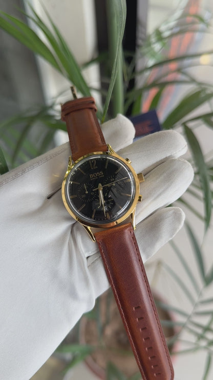 Yellow gold with black dial and brown strap